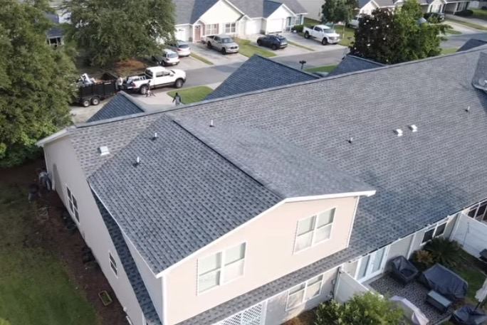 Completed roof with the crew's truck and dump trailer on site
