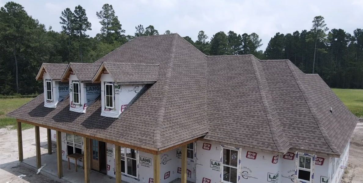 New construction home with a completed shingle roof